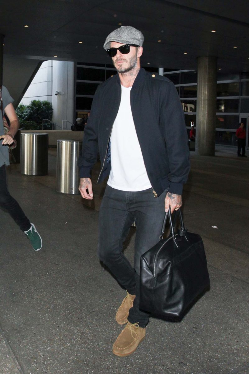 David Beckham wearing Black Long Sleeve Henley Shirt, Navy Jeans, Tan  Leather Casual Boots, Brown Leather Watch | Lookastic