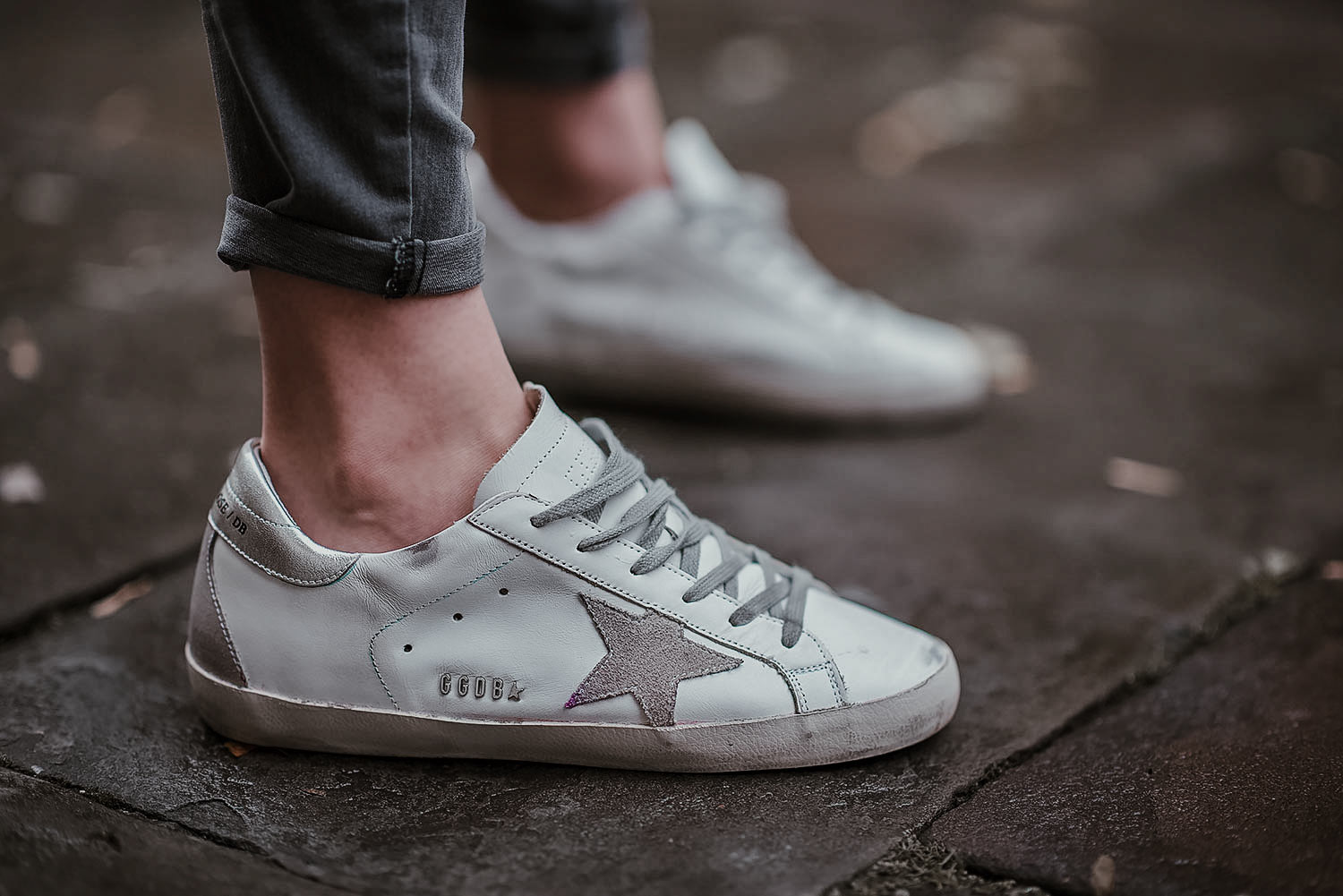 Golden goose sale sneakers on feet