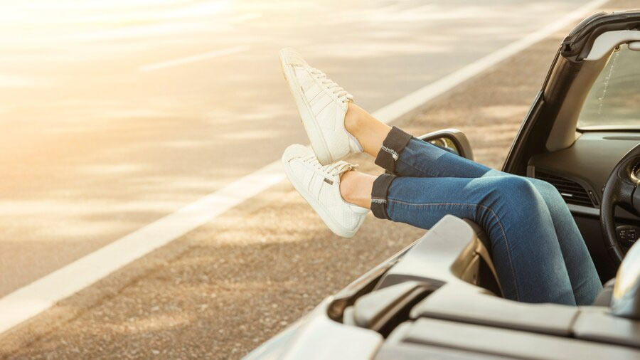 woman in stretch jeans relaxing in a car