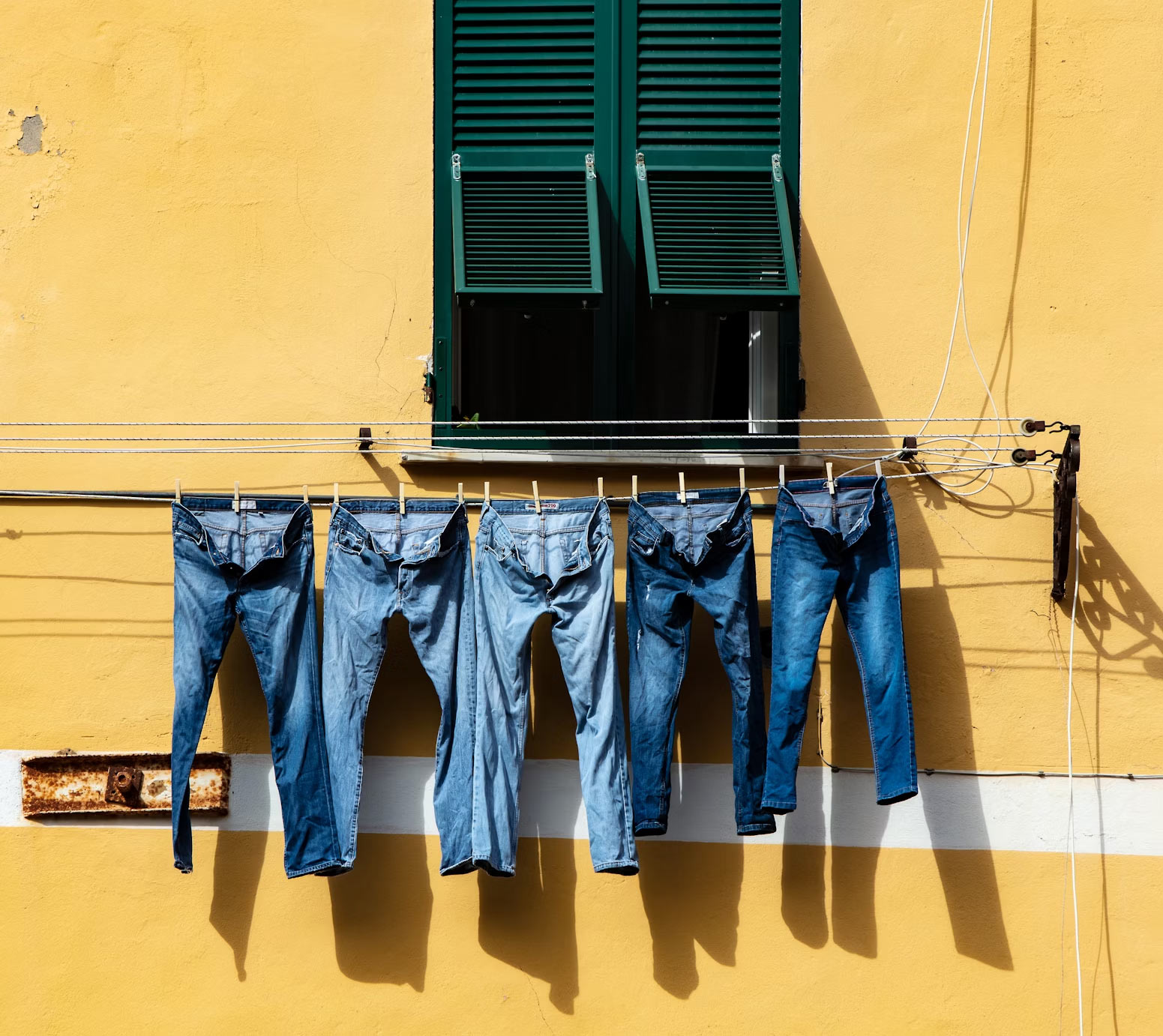 blue denim jeans hanging to dry