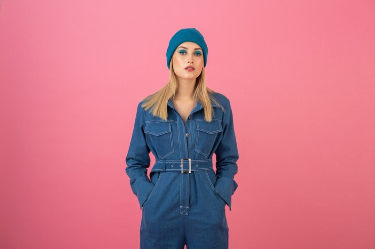 woman in denim jumpsuit with beanie