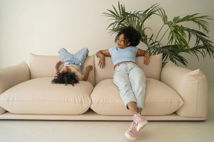 woman and child relaxing on sofa