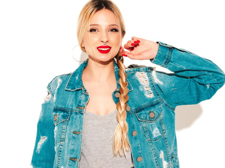 Smiling woman in distressed denim jacket